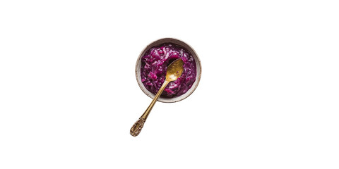 A small bowl of purple cabbage jam with a gold spoon on a white background
