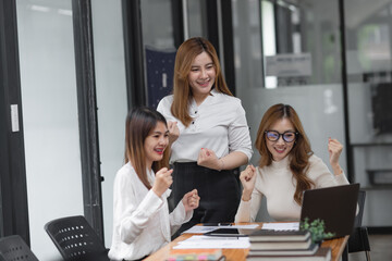 Group of young asian businesswoman working and brainstorming in workshop and analyzing marketing reports startup project infographics in the office.
