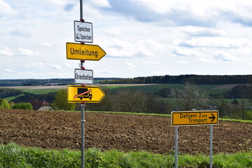 many traffic signs at the roadside