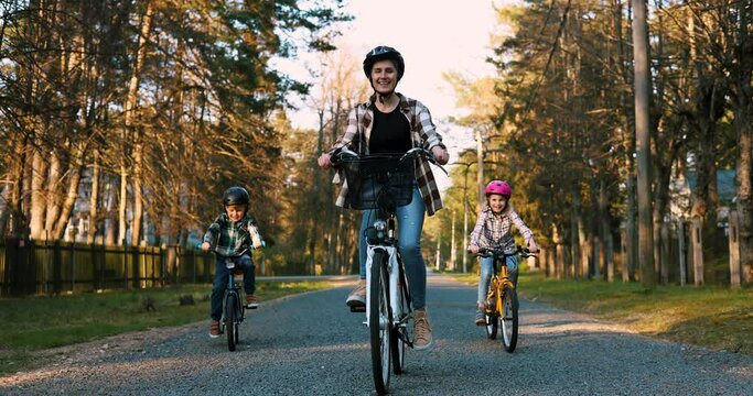 happy mother with children on a bike ride