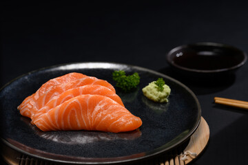 Sliced raw fatty salmon or salmon sashimi serve on with wasabi. Japanese food style concept
