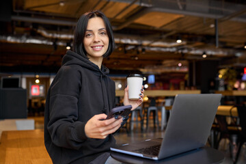Young businesswoman spending time in a cafe with a laptop