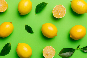 Many fresh ripe lemons as colored background, top view. Elegant background of lemon and lemon...