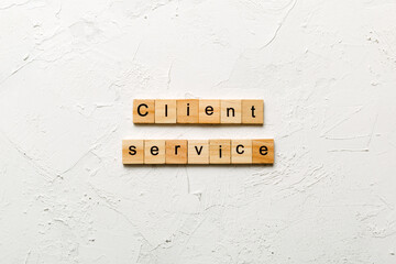 Client service word written on wood block. Client service text on cement table for your desing, concept