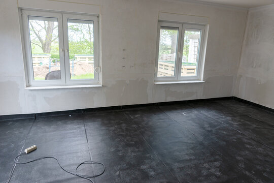 Professional Installation of Black Polyethylene Vapor Barrier on the floor