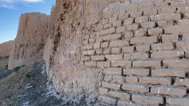 Turkestan walls of the ancient city of Sauran on a sunny day with a blue sky. Ancient buildings, fortress, ruins, ancient architecture in the settlement of Sauran. Archaeological excavations.