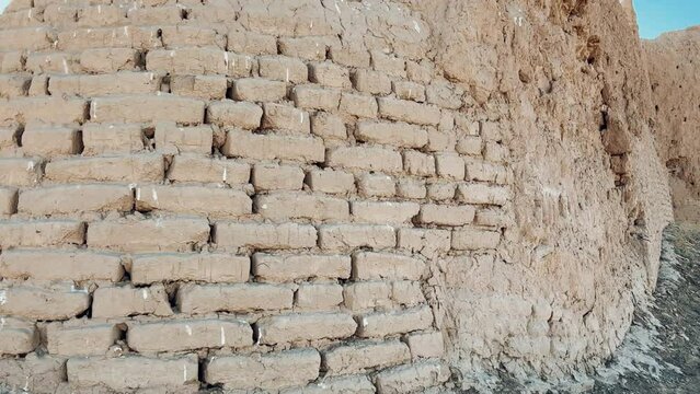 Turkestan walls of the ancient city of Sauran on a sunny day with a blue sky. Ancient buildings, fortress, ruins, ancient architecture in the settlement of Sauran. Archaeological excavations.