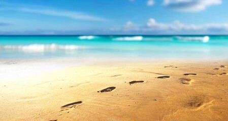 Blurred defocused natural background of tropical summer beach with footprints in the wet sand....