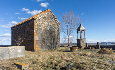 Old church and bell tower of Sabechisi village, Georgia. Graveyard and gravestones.