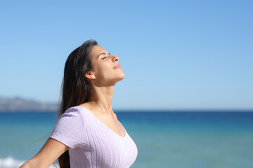 Casual woman breathing and relaxing on the beach