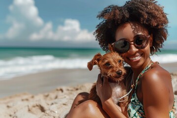 Happy african american woman hugging dog together on sea beach