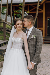 Naklejka premium A bride and groom are standing together, the bride wearing a white dress and the groom wearing a suit