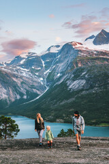 Family walking outdoor traveling together in Norway - mother, father and child on summer vacation...
