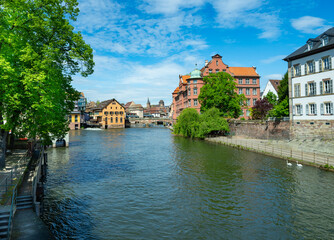 Strasbourg. Old town. waterside promenade  of the Ill near Covered bridge Pont  in the district...