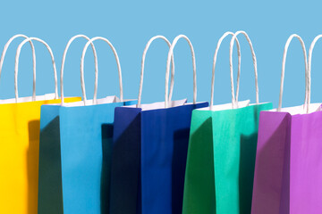 Colorful paper bags against blue background
