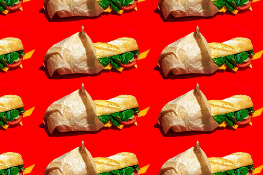 Seamless pattern of cheese sandwich on red background