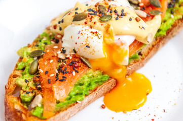 toast with avocado, smoked salmon, seeds and a poached egg