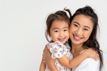 Happy young asian woman mother with her little daughter