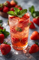 Strawberry mocktail garnished with fresh mint leaves, presented elegantly against a clean white backdrop