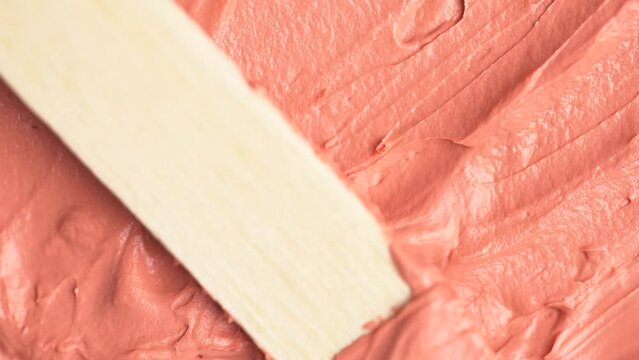 Top view of orange clay and mud face mask smooth creamy texture, macro shot