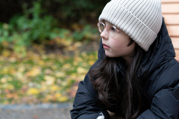 Portrait of a beautiful young girl in a hat and coat.