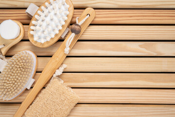 Zero waste, skin care brush set on wooden background.