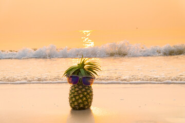 Pineapple wearing sunglasses with golden hour.
