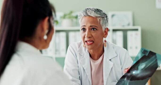 Xray, healthcare and doctor explaining to patient in hospital office for diagnosis or treatment. Discussion, radiology and senior medical worker talking to woman with body scan in medicare clinic.