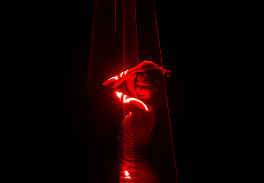 Beautiful woman dancing under red illumination, laser light, neon party night club. Projection mapping. Interactive exposition installation. - Powered by Adobe