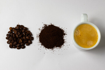 Roasted coffee beans and coffee in a mug