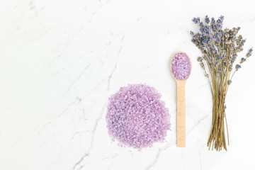 Lavender bath salt and lavender sprigs on a marble vanity in the bathroom