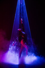 Gorgeous woman under colorful illumination, laser light, neon smoke club. Projection illusion mapping. Futuristic model.
