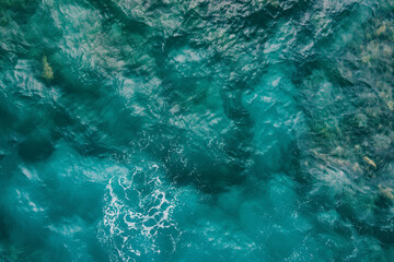 Aerial view of a turquoise water surface texture in a flat lay shot from a top down perspective in a close up