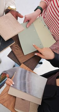 Expert interior designers collaborated, selecting materials for home makeover wooden, marble textures, and fabric swatches in focus for perfect interior design. Vertical video about interior design.