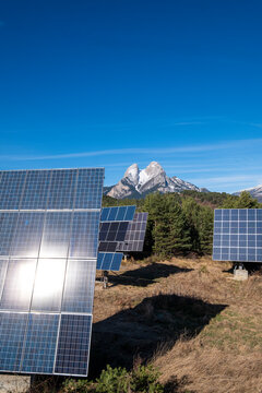 The towering Pedraforca peak in Catalonia, Spain, rises behind a field of advanced solar panels, emblematic of the region's commitment to sustainable mountain energy solutions