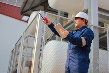 Portrait of professional man engineer working checking work place to keep liquid helium in industry.