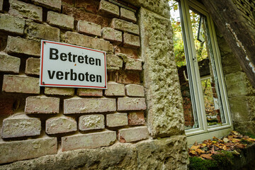 Lost place with german sign do not enter at a wall