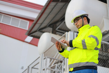 Portrait of professional man engineer working checking work place to keep liquid helium in industry.