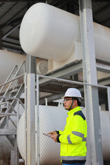 Portrait of professional man engineer working checking work place to keep liquid helium in industry.