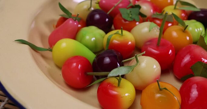 Colourful fruit vegetable shaped Thai sweet mung bean coconut milk desert luk chap candy variety pan rotate move
