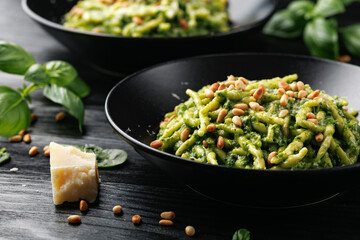 Trofie pasta with creamy spinach sauce and toasted pine nuts