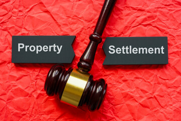 Property settlement concept. Split tablet and gavel on crumpled paper.