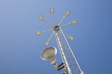 Streetlights and loudspeaker on blue background