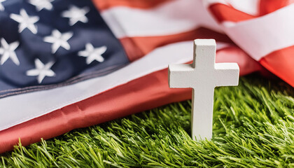 White grave cross and American flag on green meadow. Memorial day, federal holiday in the US