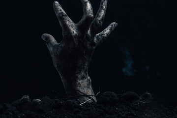 Zombie hand coming out of the ground, halloween concept.