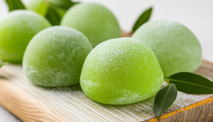 Delicious green mochi on wooden board. Traditional Japanese dessert. Rice cake. Sweet and tasty food