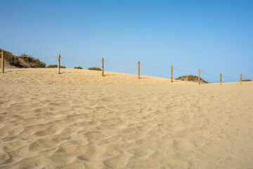 Sand dune with a fence
