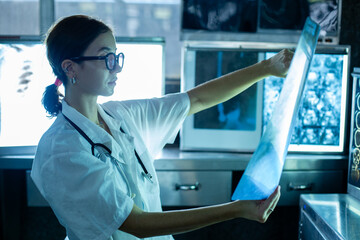 Medical female specialist checkup analytics x-ray film scan examining in laboratory at hospital....