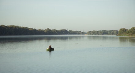 fishing activity one man in the boat back to camera on river morning time picture