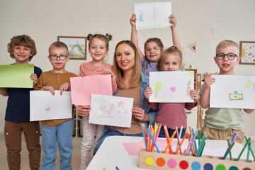 Group of children showing their art drawings